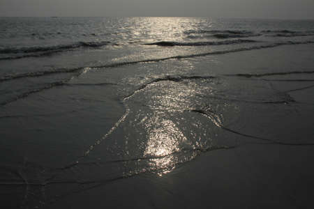 Dark Sea and Wet Sandの写真素材