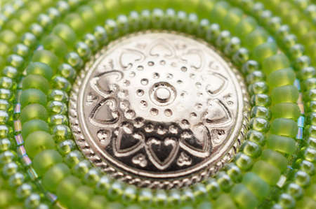 Seed bead embroidered green mandala with metal button. Hand made art objectの写真素材