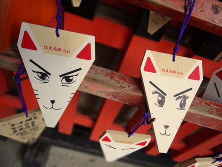 Kyoto, Japan - 4th August 2018 : Close up of fox shape Ema's (small wooden wishing plaques) hanging at the Fushimi Inari Thaisha Shrine in Kyoto, Japanのeditorial素材
