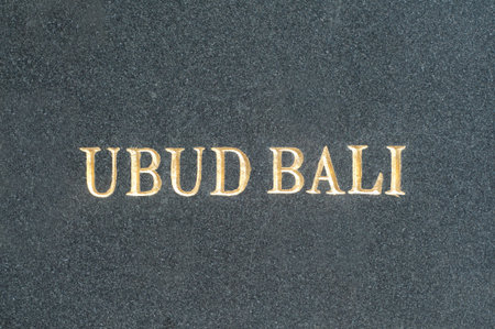 Gilded Ubud-Bali inscription on a black marble slab located in the center of Ubud, Bali, Indonesia