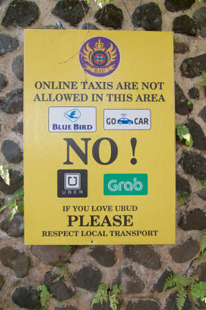 Ubud, Bali, Indonesia - 15th May 2019 : Protest sign place from local people in Ubud against the online taxi services like Uber, Grab etc. located in the village of Ubud, Bali - Indonesiaのeditorial素材
