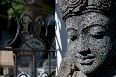 Side close up of a beautiful small Buddha stone statue located in Ubud, Bali - Indonesia