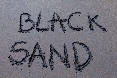 Black sand inscription drawn on a black sand beach near Canggu, Bali - Indonesiaの写真素材