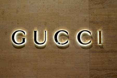 Lugano, Ticino, Switzerland - 12th July 2019 : View of the Illuminated Gucci sign in the City of Lugano, Switzerland. Gucci is know for his luxury leather and fashion goods.のeditorial素材