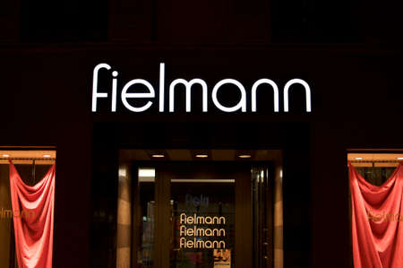 Lugano, Ticino, Switzerland - 12th July 2019 : Night view of the Fielmann store entrance in the city of Lugano. Fielmann is a german eye-wear company the largest in Europeのeditorial素材