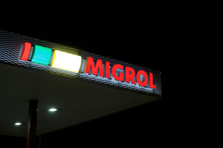 Agno, Ticino, Switzerland - 2nd October 2019 : View of the luminous Migrol gas station in Agno,...