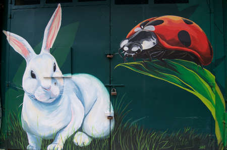 Chinatown, Kuala Lumpur, Malaysia - 9th May 2019 : Beaufitul Mural of a white rabbit and a ladybug painted on a building facade in the Bukit Bintang district in Kuala Lumpur, Malaysiaのeditorial素材