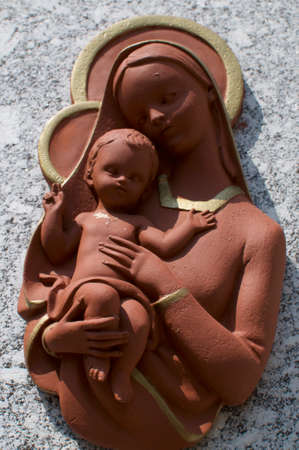 Close up of a clay statue that portraits the Virgin Mary (Maria) and baby Jesusの写真素材