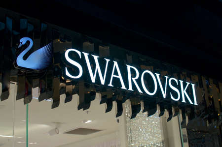 Brisbane, Queensland, Australia - 11th December 2019 : View of the an illuminated Swarovski logo hanging in front of the store in Brisbane. Swarovski is an Austrian producer of glass and jewelleryのeditorial素材