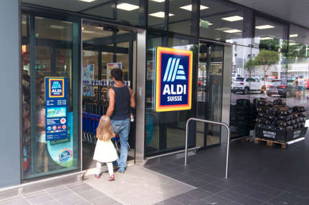 Lugano, Ticino, Switzerland - 19th August 2019 : People entering a Aldi supermarket shop in Switzerland. ALDI is a german company and one of the biggest discount supermarket chains in the worldのeditorial素材