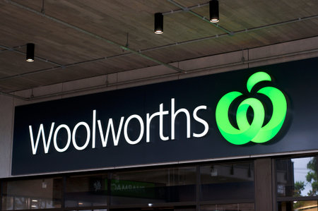 Byron Bay, New South Wales, Australia - 10th February 2020 : Glowing Woolworths sign hanging in...