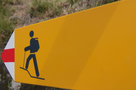 Close up of a hiking trail direction sign captured in the swiss alpsの写真素材