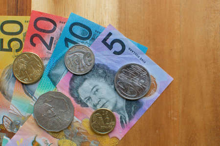 Close up picture of Australian banknotes and coins on a wooden table. Currency and money from Australiaの写真素材