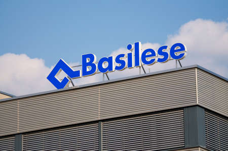 Manno, Ticino, Switzerland - 21st March 2020 : Basilese Insurance (Basler Versicherungen) Logo hanging on top of a building in Manno. BÃ¢loise Holding AG is a Swiss insurance holding companyのeditorial素材