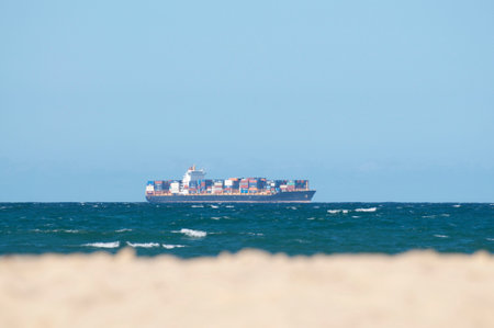 View of a loaded container cargo freight ship on the sea in Australia