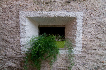 Typical old stone window of a the old village center of Bigorio in the Capriasca region in Ticino Canton, Switzerlandの写真素材