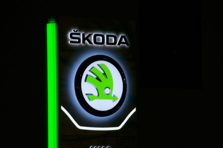 Lugano, Ticino, Switzerland - 3rd December 2020 : Luminous Czech Skoda car dealership logo hanging...