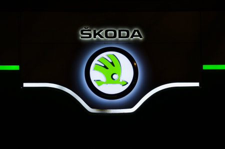 Lugano, Ticino, Switzerland - 3rd December 2020 : Luminous Czech Skoda car dealership logo hanging in front of the garage building in Lugano. is a Czech automobile manufacturer founded in 1895のeditorial素材