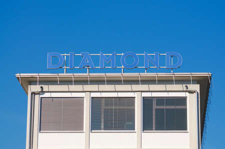 Locarno, Ticino, Switzerland - 16th January 2021 : Diamond SA company sign hanging on the building in Losone, Switzerland. Diamond is a Swiss company specialized in fiber optics productionのeditorial素材