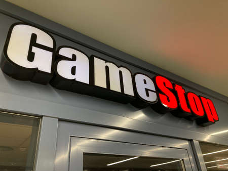 Zug, Switzerland - 6th February 2021 : GameStop logo hanging over a store entrance in Zug, Switzerland. GameStop is an American company that sells video gameのeditorial素材