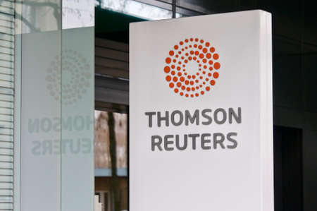 Zug, Switzerland - 26th February 2021 : Thomson Reuters sign hanging in front of the office entrance in Zug, Switzerland. Thomson Reuters is a Canada-based multinational media conglomerateのeditorial素材