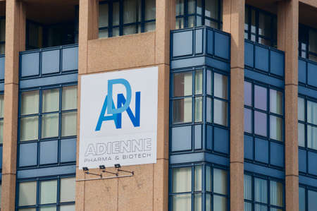 Lugano, Switzerland - 9th March 2021 : Adienne Pharma & Biotech SA sign on the headquarters building in Lugano. Adienne Pharma & Biontech company will manufacture the Sputnik V vaccine for europeのeditorial素材