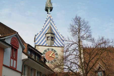 Close up view of the Zytturm clock tower building in the historical city center of Zug in Switzerlandの写真素材