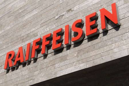 Wohlen, Aargau, Switzerland - 15th April 2021 : Swiss Raiffeisen bank sign on a concrete facade in Wohlen. Raiffeisen is a Swiss cooperative bank, the third largest bank in Switzerlandのeditorial素材