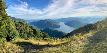 Beautiful panoramic view on the Lugano Lake and the Mendrisiotto region from Monte Sighignola on the border of Italy and Switzerland on a sunny dayの写真素材