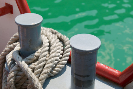 Close up picture of two bollards with mooring rope of a tourism boat on the lake Lugano, Switzerland