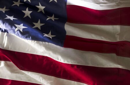 Isolated American flag waving in highlights and shadowの写真素材