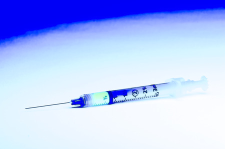 high contrast image of a hypodermic syringe with medicineの写真素材