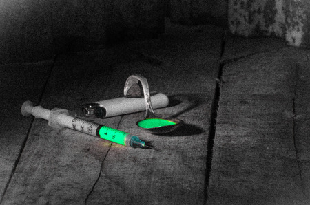 drug abuse  paraphernalia on dirty, dank floor of a backroomの写真素材