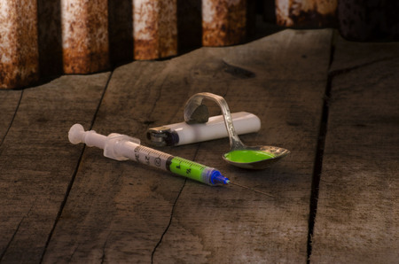 drug abuse  paraphernalia on dirty, dank floor of a backroomの写真素材