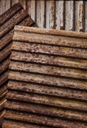 rusty corrugated metal under smooth lightの写真素材