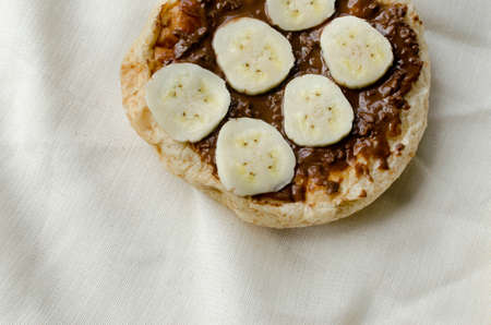 Bread with chocolate cream and slices of bananaの写真素材