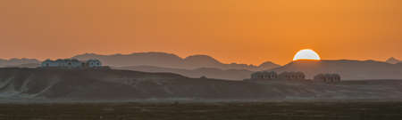 The sun setting over the desert behind the Wadi Lahami accommodation in the south of Egypt. Juneの写真素材