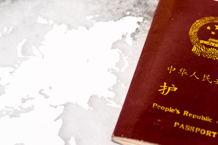 Chinese passport on grunge world mapの写真素材