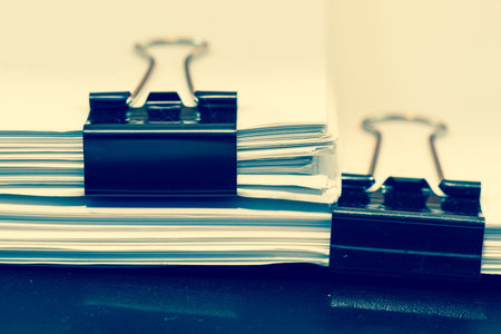 Piles of documents with black clip