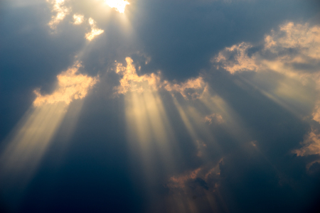 Lights of sunset through cloudsの写真素材