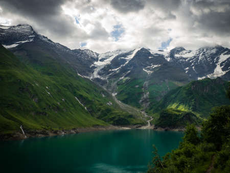 Scenic view on Wasserfallboden See near Kaprun, Austria, Europe. National park Hohe Tauern. Charming lake with amazing deep colorful water and wild clouds on sky.の写真素材