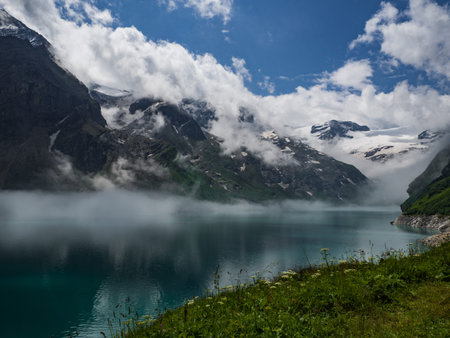 Scenic view on Mooserboden See near Kaprun, Austria, Europe. National park Hohe Tauern. Charming lake with amazing deep colorful water and glaciers above it. Favourite destination for holidays.の写真素材