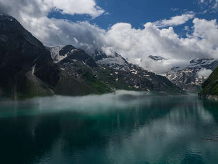 Scenic view on Mooserboden See near Kaprun, Austria, Europe. National park Hohe Tauern. Charming lake with amazing deep colorful water and glaciers above it. Favourite destination for holidays.の写真素材