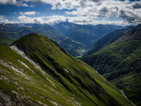 Great views to the peaks, valleys and glaciers of the Austrian Alps, Hohe Tauern national park. Charming and beautiful scene with amazing meadows, near nice city Heiligenblut, Austria, Europe.の写真素材