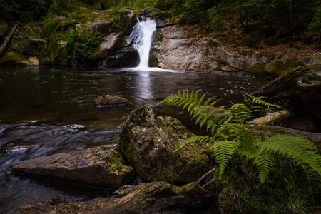 Amazing waterfall hidden deep in Jizera mountains, Czech Republic. Calm and peaceful place with water flowing in cascade river.の写真素材