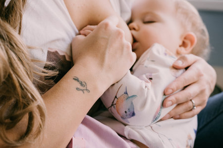 Breastfeeding a child, tender and loving moment, motherhood. Motherly care, bond, affection. Feeding...