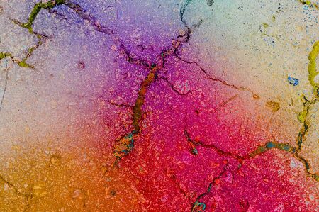 Old asphalt cracked background texture painted with rainbow processの写真素材