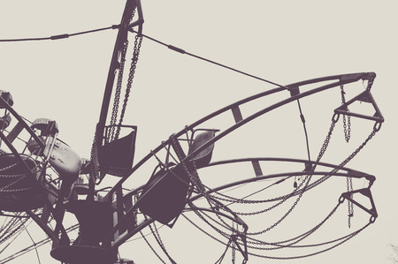 Fragment of carousel in the abandoned park. Monochrome old style photo.の写真素材