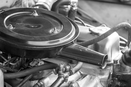 Under the hood cover of an old vintage car. Monochrome style photo.