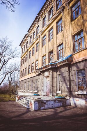 Old abandoned building. Ruined school. Destroyed construction.の写真素材